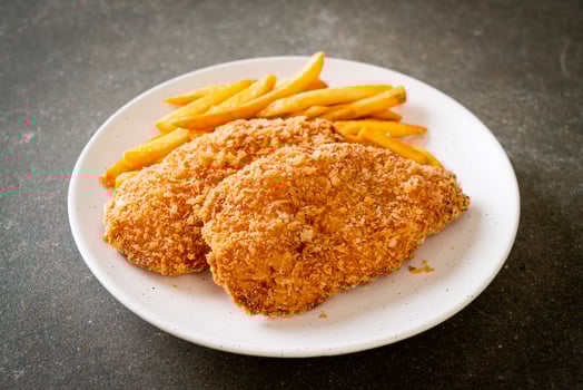 Fried chicken breast fillet steak with French fries and ketchup photo