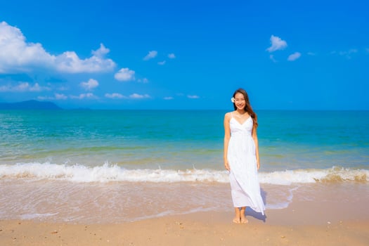 Portrait beautiful young asian woman happy smile leisure on the beach sea and ocean photo