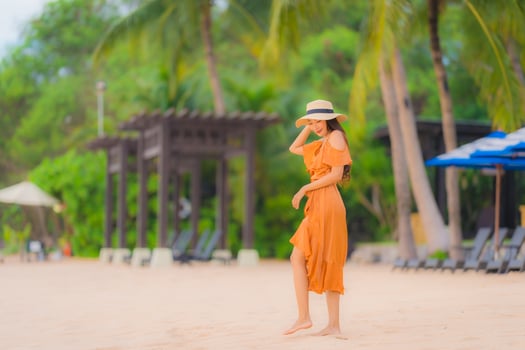 Portrait beautiful young asian woman happy smile relax on the beach sea ocean photo