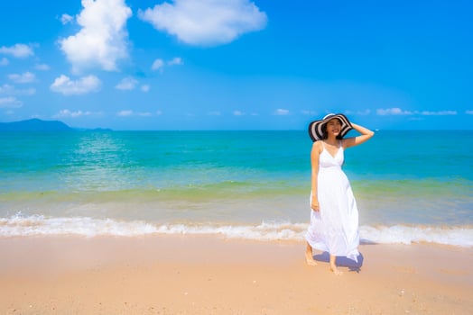 Portrait beautiful young asian woman happy smile leisure on the beach sea and ocean photo