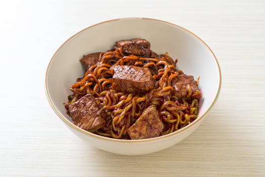 Jjapaguri or Chapaguri Korean Black Beans Spicy Noodles with Beef photo