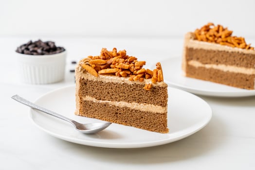 Homemade coffee almonds cake on white plate photo