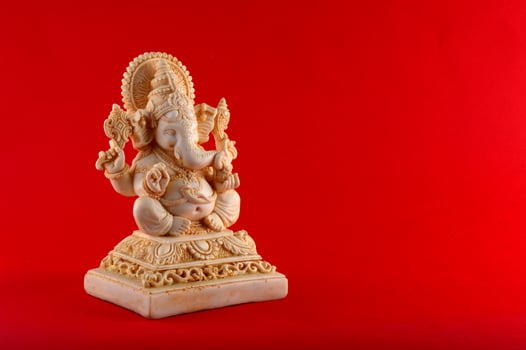 Hindu God Ganesha. Ganesha Idol on red background photo