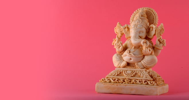 Hindu God Ganesha. Ganesha Idol on pink background photo