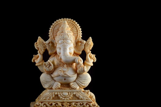 Hindu God Ganesha. Ganesha Idol on brown background photo