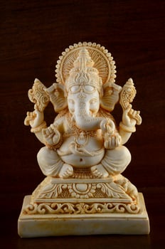 Hindu God Ganesha. Ganesha Idol on brown background photo