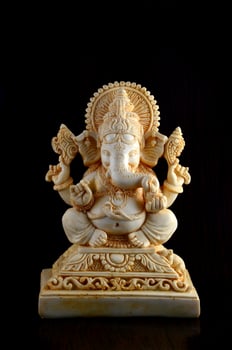 Hindu God Ganesha. Ganesha Idol on brown background photo