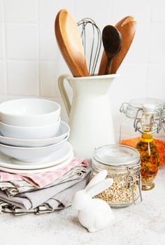 Kitchen utensils, tools and dishware on on the background white tile wall. photo