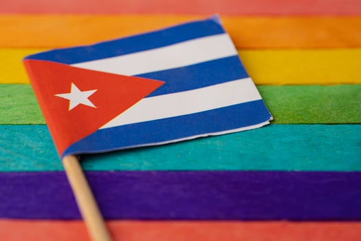 Cuba flag on rainbow background flag symbol of LGBT gay pride month  social movement rainbow flag is a symbol of lesbian, gay, bisexual, transgender, human rights, tolerance and peace. photo