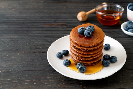chocolate pancake stack with blueberry and honey photo
