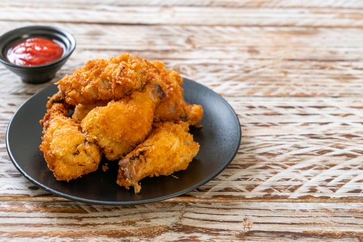 Fried chicken wings with ketchup - unhealthy food photo