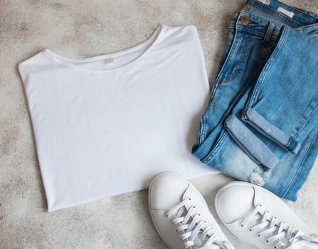 Stylish female clothes set. Woman outfit on concrete background. photo