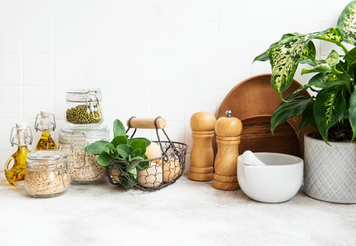 Kitchen utensils, tools and dishware on on the background white tile wall. photo