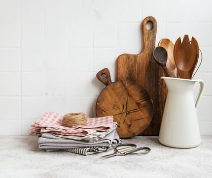 Kitchen utensils, tools and dishware on on the background white tile wall. photo