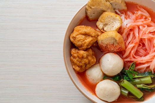 Small flat rice noodles with fish balls and shrimp balls in pink soup, Yen Ta Four or Yen Ta Fo - Asian food style photo