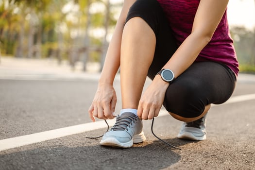 closeup of young woman runner tying her shoelaces. healthy and fitness concept. photo