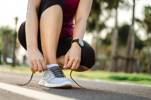 closeup of young woman runner tying her shoelaces. healthy and fitness concept. photo