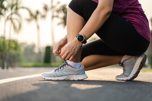closeup of young woman runner tying her shoelaces. healthy and fitness concept. photo