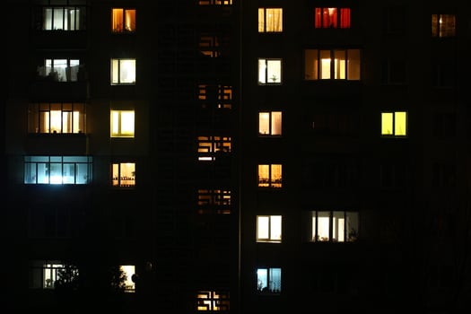 Windows at night. House building lights seamless background photo