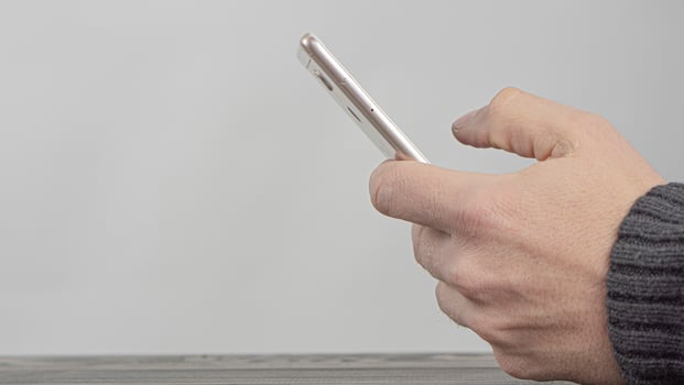 Male Hands Holding A Mobile Phone photo