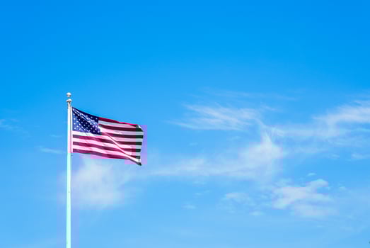 Amaerican flag on pole with blue sky photo