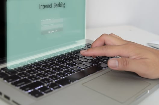 Hand is typing the computer keyboard on virtual screen internet banking.Business finance technology concept photo