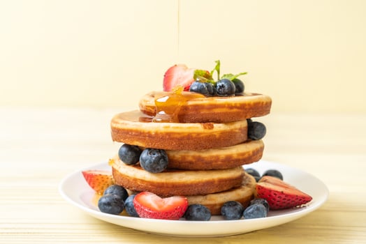 Souffle pancake with fresh blueberries, fresh strawberries and honey photo