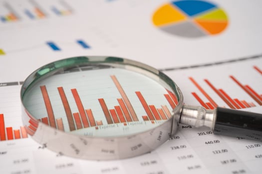 Magnifying glass on charts graphs paper. Financial development, Banking Account, Statistics, Investment Analytic research data economy, Stock exchange trading, Business office company meeting concept. photo