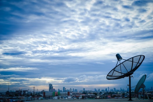 Satellite dish antenna on top of the building in urban area photo