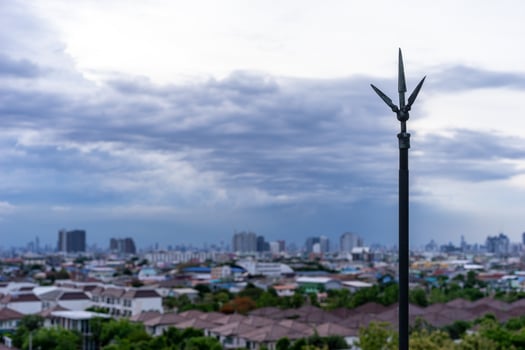 Lightning rod on the rooftop of condominium with cloudy sky photo