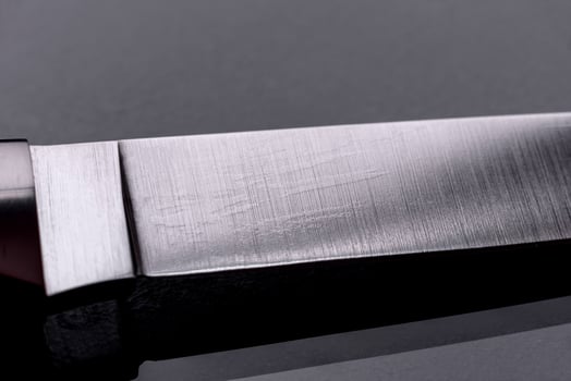 A large handmade hunting knife lying on a dark background photo