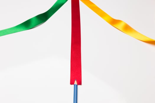 Coloured pencils wrapped in a green ribbon photo