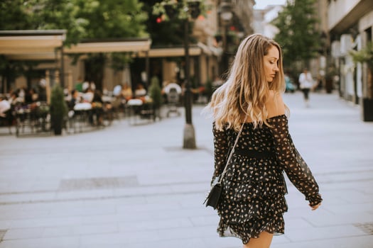 Young long hair brunette woman walking on the street photo