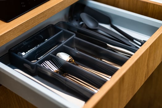 Kitchen box with cutlery. Spoons, forks, knives, pots. photo