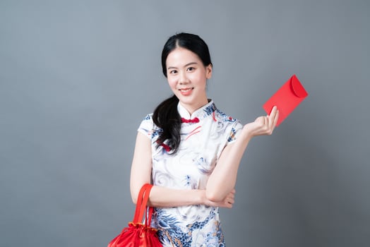 Asian woman wear Chinese traditional dress with red envelope or red packet photo