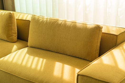 Empty golden mustard sofa in living room photo