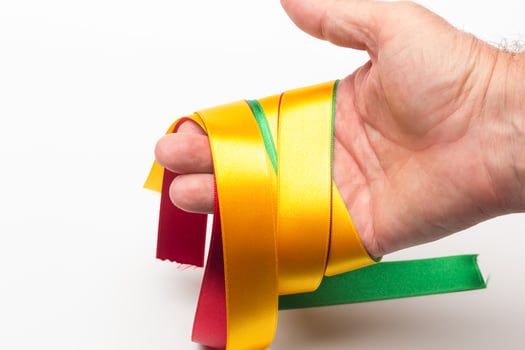Hand with coloured ribbon photo