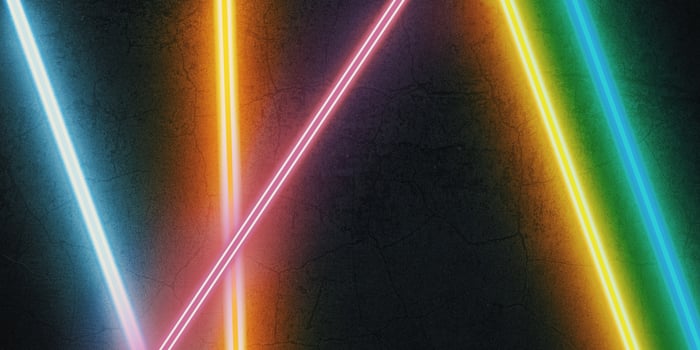 multi color laser light shining on a black stone background photo