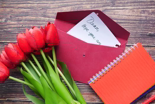 envelope , letter and tulip flower on table photo