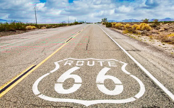 Route 66 road sign with blue sky background. photo