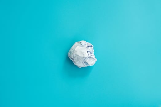 Close up white paper crumpled on wooden background photo