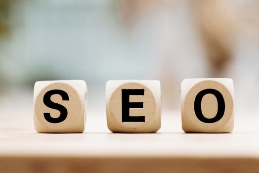 SEO concept with wooden block on wooden table background photo