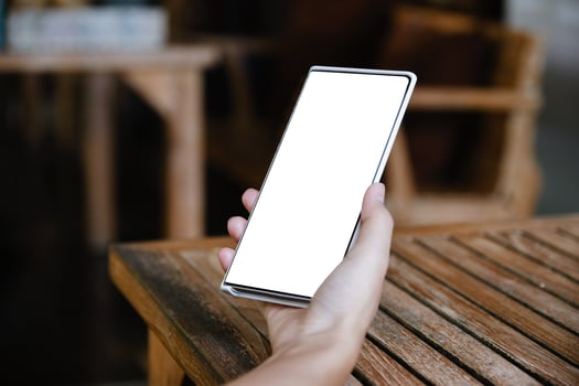 Woman hand holding smartphone  Blank screen mobile phone photo