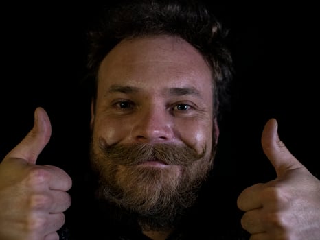 funny face of a man with a beard and mustache and showing thumbs up photo