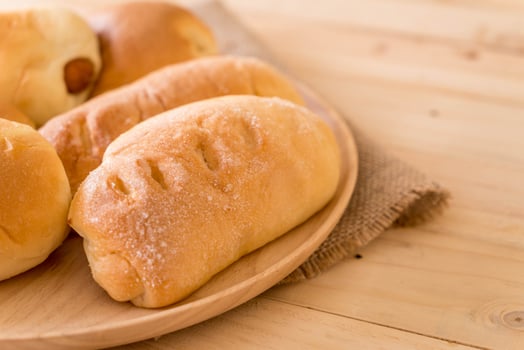 Bread in wood plate on the table photo