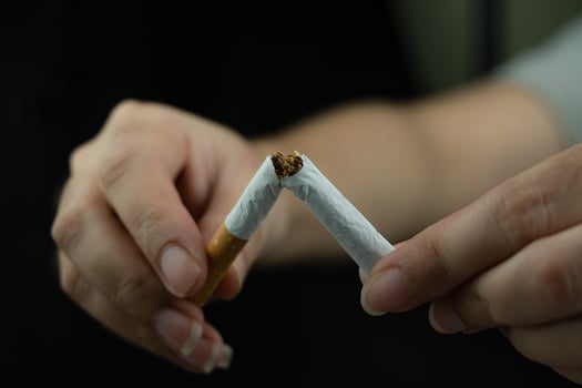 Women hand crushing cigarette photo