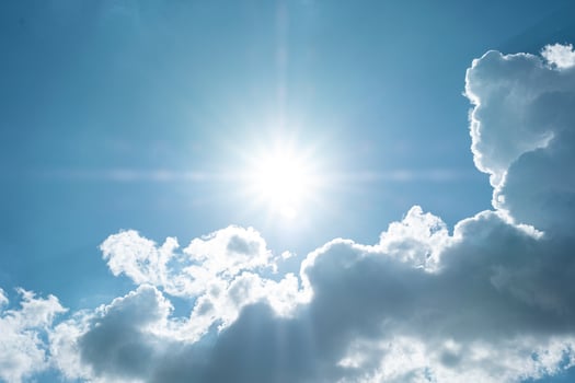 Beautiful blue sky with white clouds and sun photo
