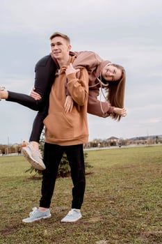 Young loving couple embracing each other outdoors in the park photo