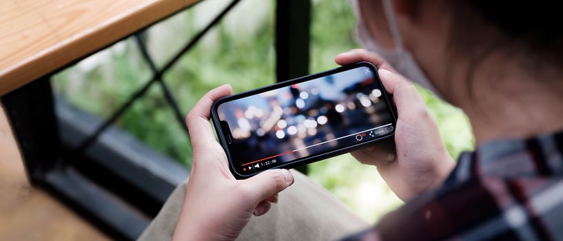 Cropped image of female hand holding smartphone photo
