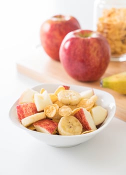 Milk, apple, banana and cornflakes for breakfast photo